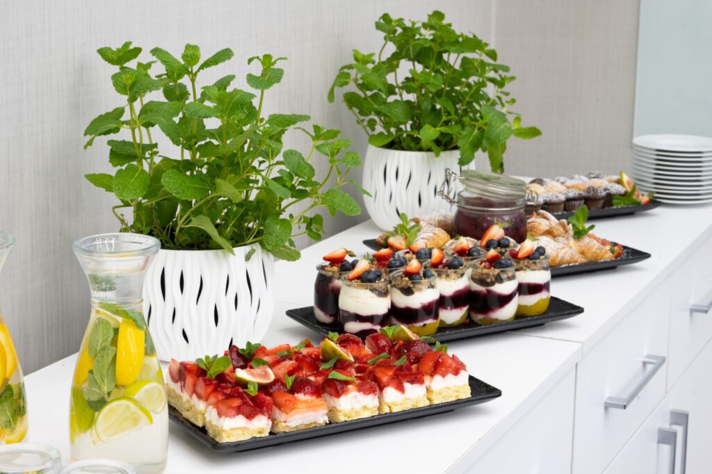 Sweet buffet with desserts in glasses, strawberry cake and lemonade